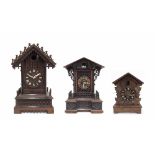 Black Forest two train cuckoo mantel clock, within a breakfront chalet case, 17" high; also