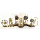 Five various contemporary torsion mantel clocks under glass domes, tallest 12" high; also two