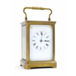 Carriage clock striking on a gong, within a corniche brass case, 7" high