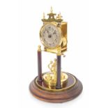 Early brass torsion clock, the 2.75" silvered dial over a disc pendulum, under a glass dome and upon