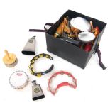 Box containing a selection of various percussion including Meinl cowbells, various rattles,