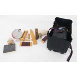 Hard travel case including a selection of small hand held percussion instruments including a