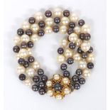 Three row iridescent black and white cultured pearl bracelet with a gold cluster clasp, 36gm, pearls