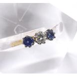 18ct sapphire and diamond three stone ring, the centre round brilliant-cut diamond 0.20ct approx,