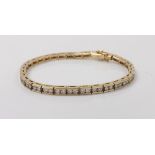 Good modern 14k yellow gold diamond line bracelet, consisting of sixty-eight round brilliant-cut