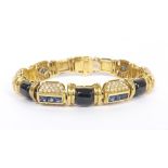 Good 18k onyx, sapphire and diamond link bracelet, consisting of seven panels each with four