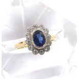 18ct sapphire and diamond oval cluster ring, the sapphire 0.75ct approx, in a surround of round