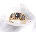 18ct sapphire and diamond claw set ring, Birmingham 1913, with three oval sapphires and four rose-