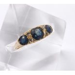 18ct sapphire and diamond ring, claw and carved set with three sapphires and four small round