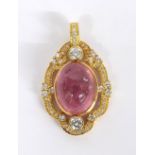 Attractive pink tourmaline and diamond oval pierced pendant, the cabouchon tourmaline in an oval