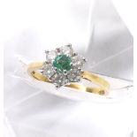 18ct emerald and diamond seven stone cluster ring, with a single diamond in a surround of six