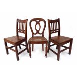 Pair of 19th century mahogany hall chairs with vertical railed slats, solid seats and square