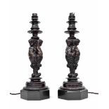 Good pair of bronze cherub candlesticks, the three faceted cherub torsos over scrolling foliage