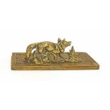 Brass desk stand modelled as a standing fox, upon repousse foliate plinth, 2.5" high, 8" wide