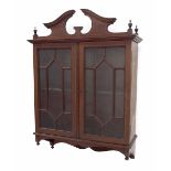 Edwardian mahogany inlaid wall display cabinet with a broken swan neck pediment over astragal glazed