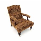 Late Victorian upholstered armchair, the button-back and padded arms with turned supports and