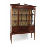 Edwardian mahogany display cabinet, the shaped raised back over twin astragal glazed doors and