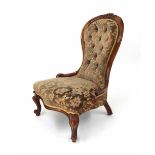 Victorian spoon back upholstered nursing chair, the foliate carved upper back over a serpentine seat