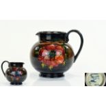 W. Moorcroft Small Signed Flambe Jug ' Anemone ' Pattern on Chocolate Coloured Ground.