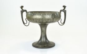 Arts And Crafts Pewter Twin Handled Pedestal Bowl with planished surface and punched roundel