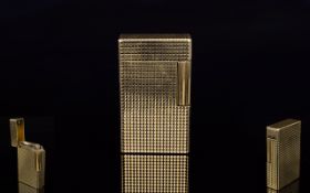 A 1970'S Gas Cigarette Lighter By S T Dupont A slim gold tone lighter with textured finish in good