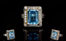 Ladies Silver Swiss Blue And White Topaz Dress Ring The central step cut brilliant blue central