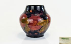 William Moorcroft Signed Globular Shaped Vase ' Pomegranates and Berries ' Design on Blue Ground. c.