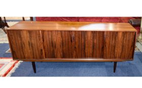 Rosewood Sideboard. Four Sliding Doors Enclosing Three Shelves And Storage.