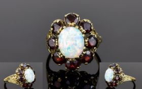 Impressive 9ct Gold Set Opal and Garnet Cluster Ring. The Oval Shaped Opal Surrounded by 8 Garnets.