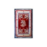 Chinese Style Red and Beige Rug with tasseled edging.