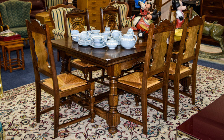 Continental Dining Set comprising extending table and chairs. The chair backs with oak carved