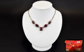 African Ruby And White Topaz Necklace Elegant necklace set with five rectangular step cut rubies,