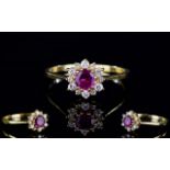 18ct Gold Dress Ring, Set With A Central Ruby Surrounded By Small Round Cut Diamonds,