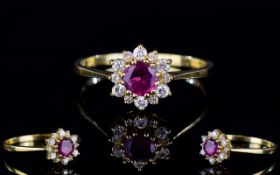 18ct Gold Dress Ring, Set With A Central Ruby Surrounded By Small Round Cut Diamonds,