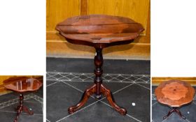 A Decorative Occasional Table, raised on