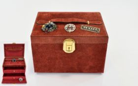 A Suede Jewellery Box And Three Brooches
