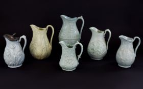 Collection of Six Floral Theme Moulded Jugs, one, Cork, Edge and Malkin; date lozenge for 1861,