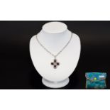 A Silver Ruby And Diamond Pendant Necklace Attractive long chain with quatrefoil ruby pendant