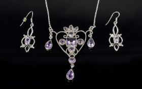 A Silver And Amethyst Set Art Nouveau Style Pendant And Earrings A delicate and intricate pendant in