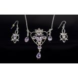 A Silver And Amethyst Set Art Nouveau Style Pendant And Earrings A delicate and intricate pendant in