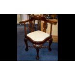 A 20th Century Chippendale Style Corner Chair With acanthus carved ball and claw feet.