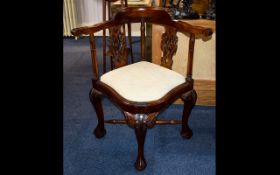 A 20th Century Chippendale Style Corner Chair With acanthus carved ball and claw feet.