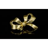 18ct Gold Bow Brooch. Polished and Bark Effect Finish to Brooch.