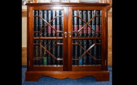 A Small Mahogany Bookcase Features astral glazed doors raised on bracket feet.