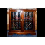 A Small Mahogany Bookcase Features astral glazed doors raised on bracket feet.