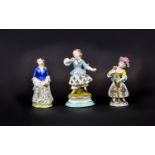 Three Various Small Female Figures comprising a Samson-Chelsea Derby figure showing a girl with a