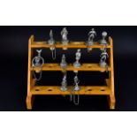 Ten Decorative Novelty Wine Stoppers housed in a pine rack with a capacity to hold 18 stoppers.