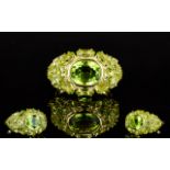 Peridot East/West Cluster Ring, to the centre a bezel set oval cut peridot of a generous 2.
