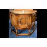 A Rustic Oak Corner Cabinet By Old Charm Small cabinet with turned legs and carved foliate arch