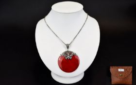 A Red Coral Disc Pendant With Silver Chain Long silver box chain with attached circular pendant